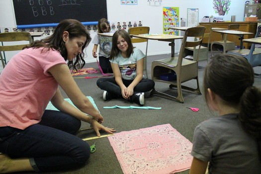 Woman Teaching Work To Two Girls